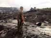 An armed pro-Russian separatist stands at a site of a Malaysia Airlines Boeing 777 plane crash in the settlement of Grabovo in 