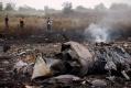 Emergencies Ministry members walk at the site of a Malaysia Airlines Boeing 777 plane crash near the settlement of Grabovo in t
